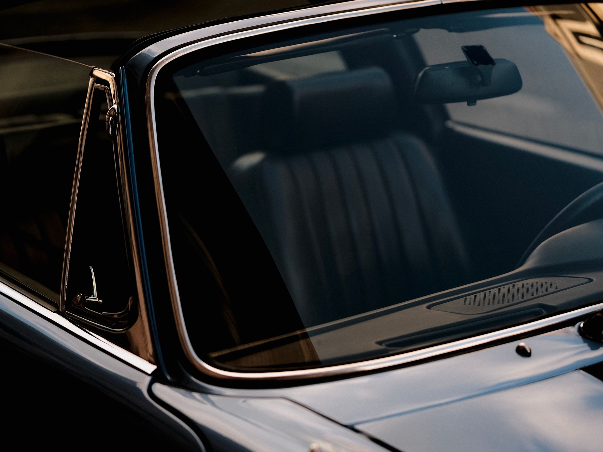 Close-up shot of a vintage car's windshield capturing a nostalgic and classic automotive style.